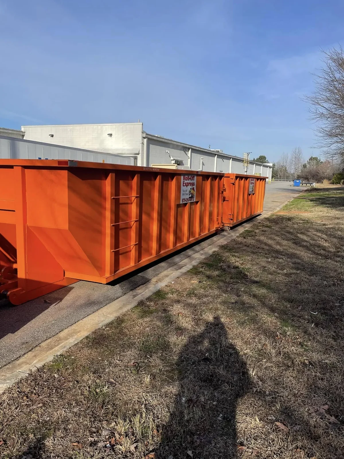 Orange Roll-Off Express dumpster at a commercial project in Georgia