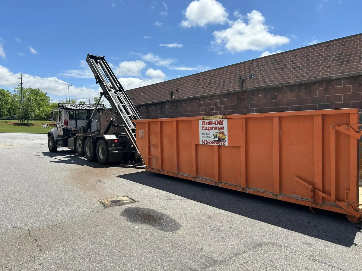 Orange Roll-Off Express dumpster at a commercial jobsite